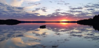 sunset with boat on a lake